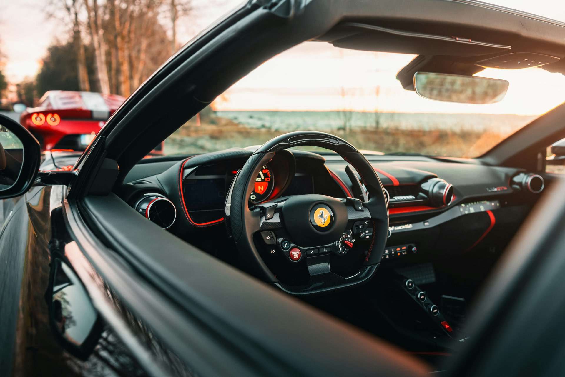 close up shot of the steering wheel of a high performance Ferrari super car, showcasing the elegant and modern design.