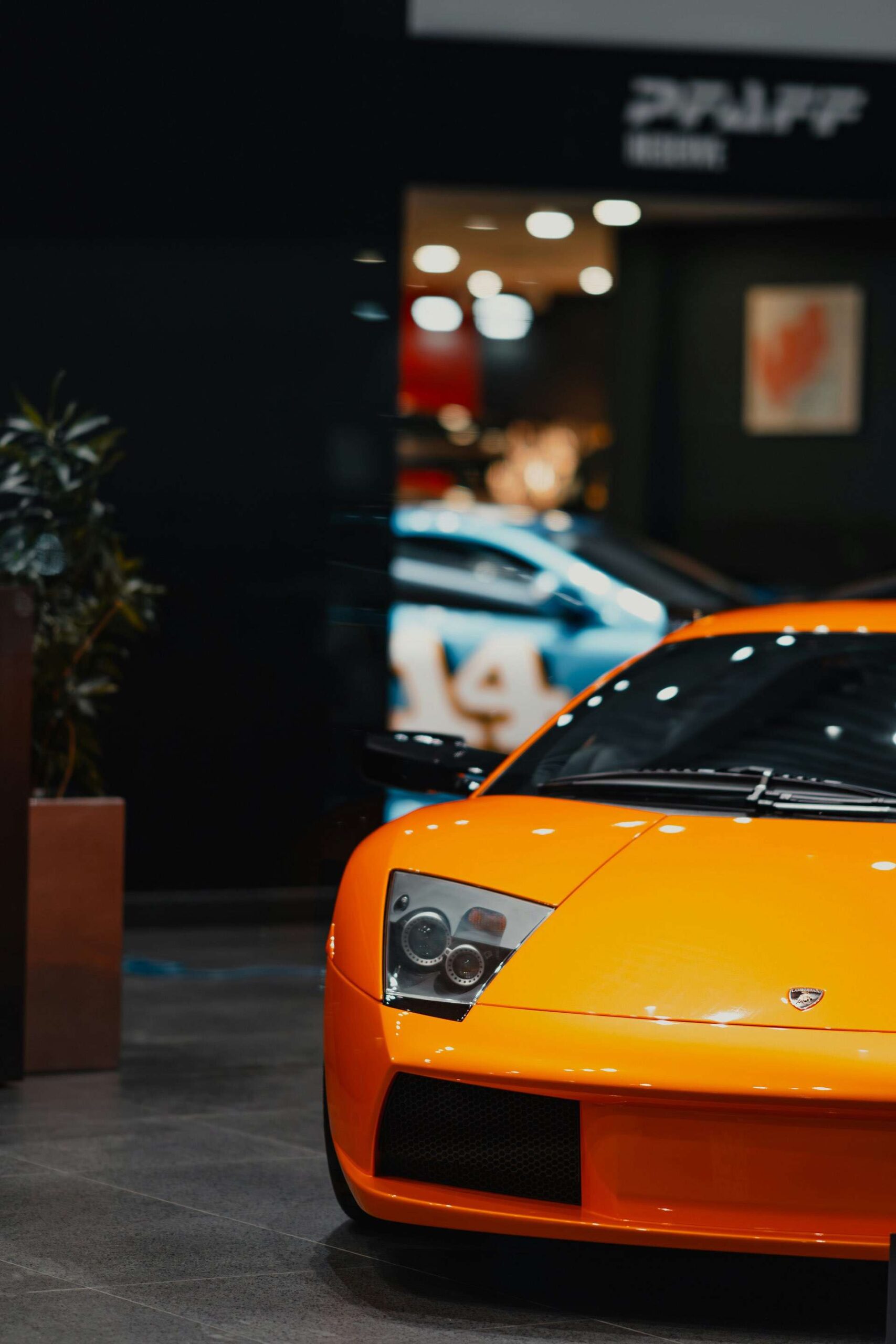 Front shot of a Lamborghini super car parked in a showroom.