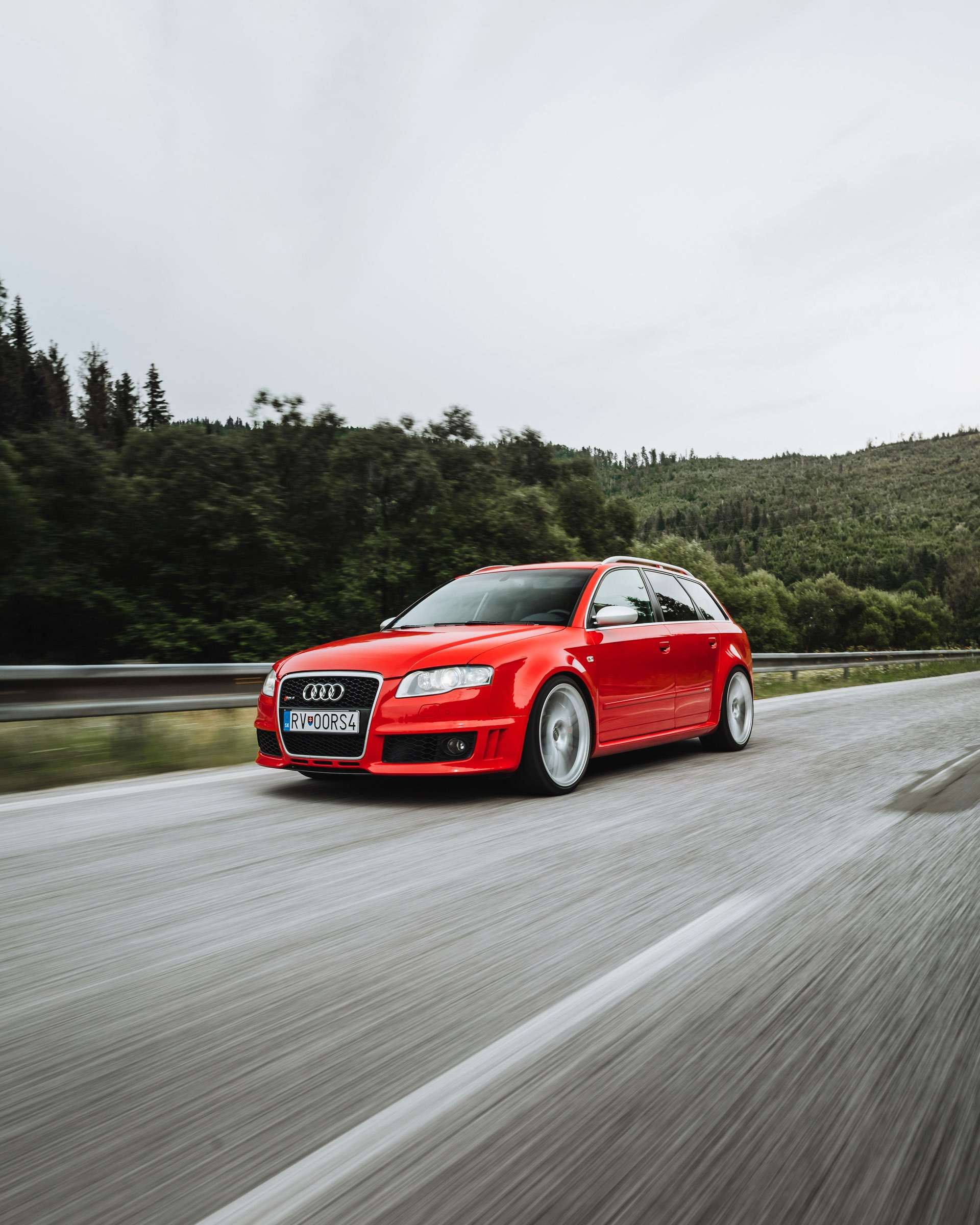 Audi RS6 driving at speed on a country road.