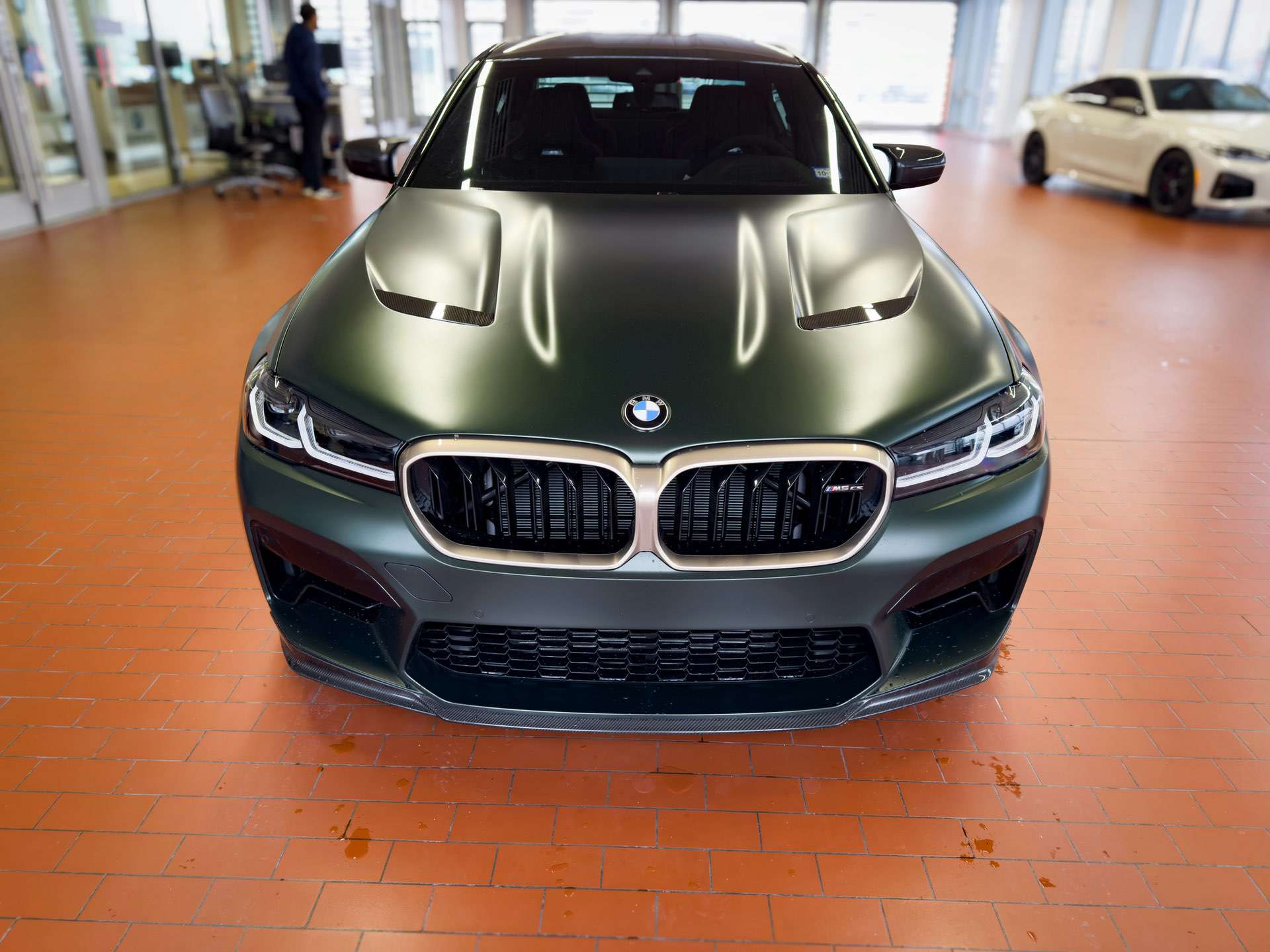 Matte BMW in a car showroom.