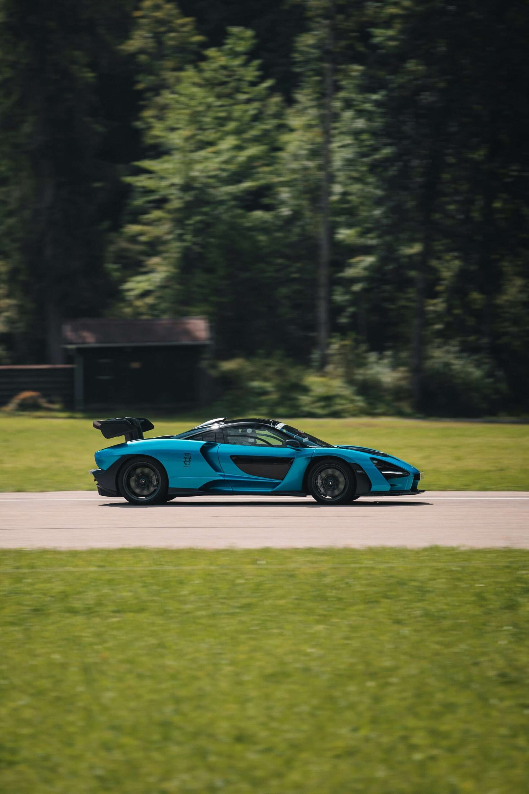 McLaren Senna in motion around a race track showcasing it's stunning speed and aerodynamics.