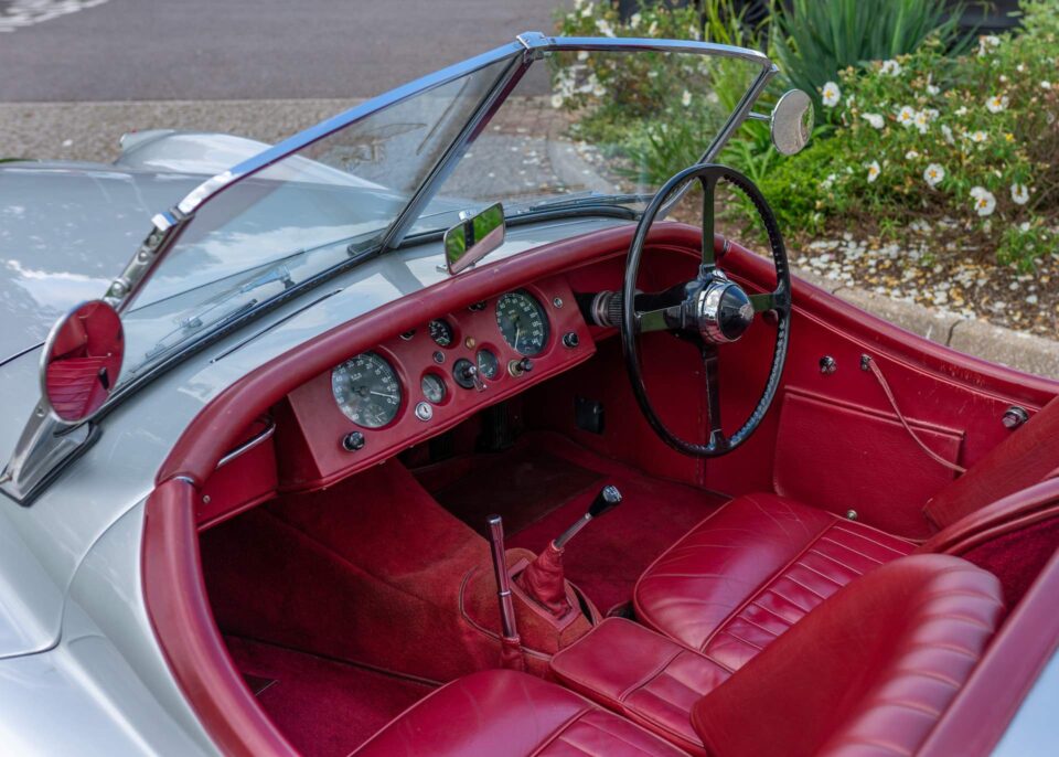 Interior of a 1953 Jaguar XK120, featuring a classic dashboard and leather seats.