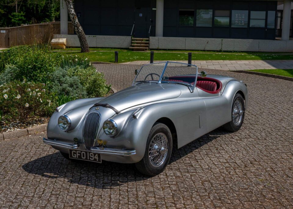 Front view of a 1953 Jaguar XK120, showcasing its distinctive grille and timeless design.