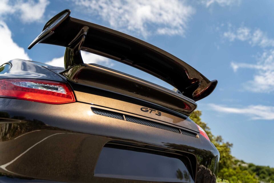 GT3 badging on the rear of a 2010 Porsche 911, signifying its high-performance heritage.