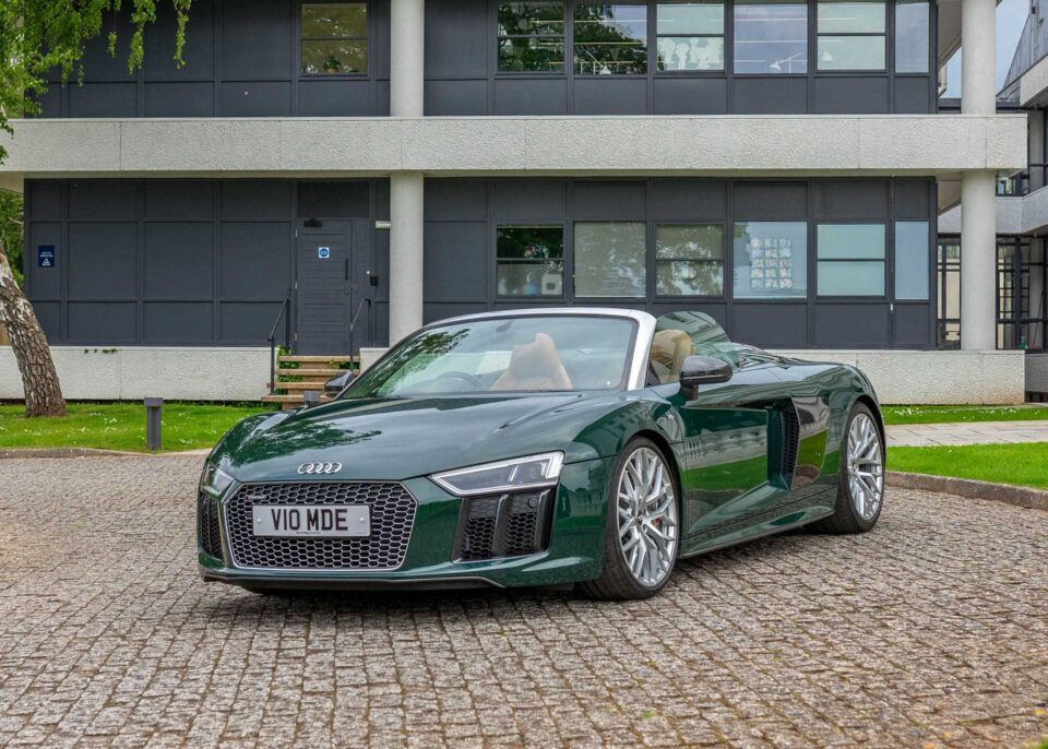 Side profile of an exotic Audi R8 supercar with aerodynamic curves and stunning wheels.