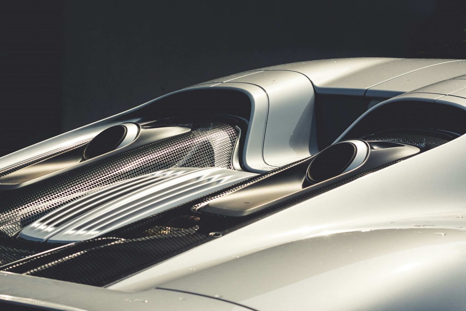 Rear view of a classic sports car highlighting its sleek lines and exhaust system.