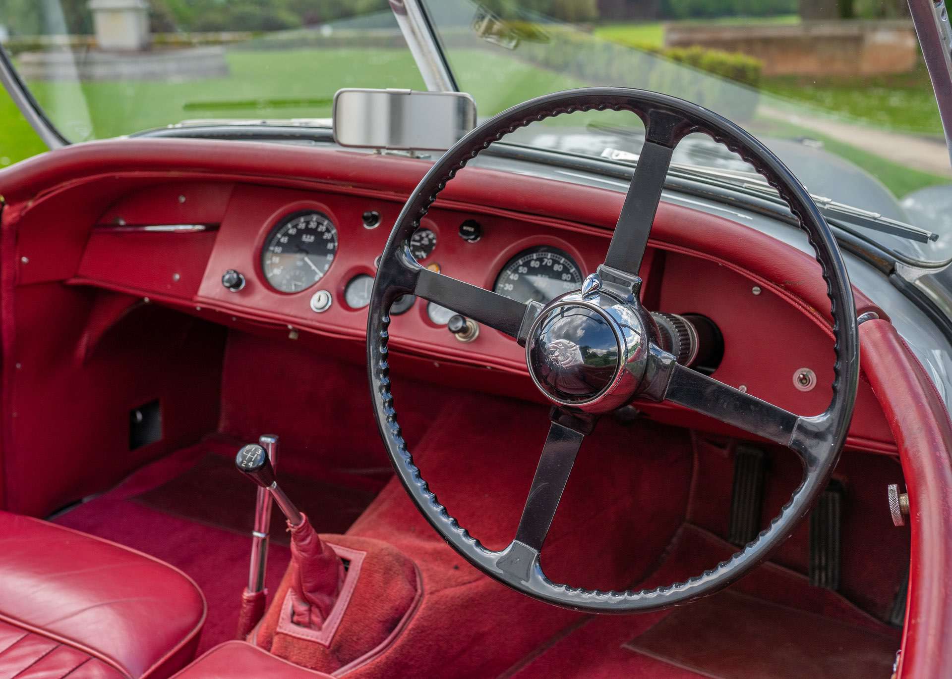 Interior of a 1953 Jaguar XK120, featuring a classic dashboard and leather seats.