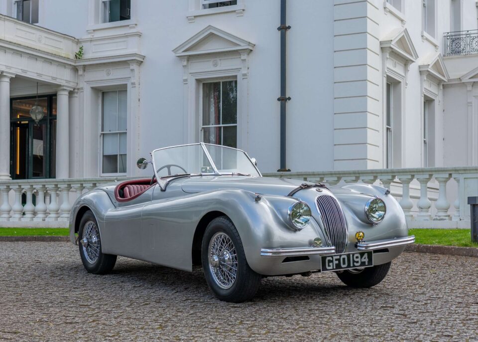 Front view of a 1953 Jaguar XK120, showcasing its distinctive grille and timeless design.